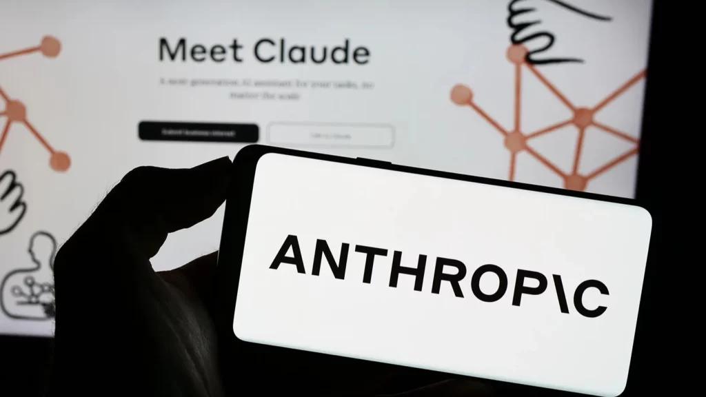 Anthropic logo displayed on a smartphone with Claude interface in the background